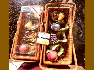  Two sets of NAPKIN RINGS  (fruit shaped) in a wicker basket from A Friend Of Rotary.