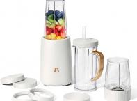 Beautiful Personal Blender by Drew Barrymore - Powerful 285 peak watt motor can effortlessly handle vegetables and frozen fruits.Compact and easy to use, just twist and blend 16oz ToGo Travel cup with handle and Drew's signature No Drippy Sippy flexible straw and twist off lid included.