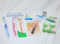 A complete set of dental care items: 2 tooth brushes, dental floss, toothpaste, 1 gum stimulator, 1 Sulcabrush, 2 packs angled flossers, and more.